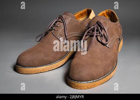 Casual brown shoes with laces on a gray background Stock Photo