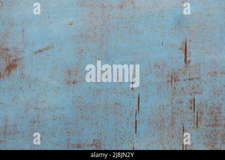 Texture of painted metal surface with small rust spots. Old metal surface painted with light blue paint, that has begun to rust, background. Stock Photo