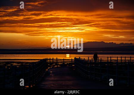 Morecambe, Lancashire, United Kingdom. 16th May, 2021. AFter heavy rain MOrecambe Bay is bathed in strong sunlight to produce a spectacular sunset Credit: PN News/Alamy Live News Stock Photo