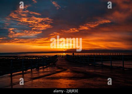 Morecambe, Lancashire, United Kingdom. 16th May, 2021. AFter heavy rain MOrecambe Bay is bathed in strong sunlight to produce a spectacular sunset Credit: PN News/Alamy Live News Stock Photo