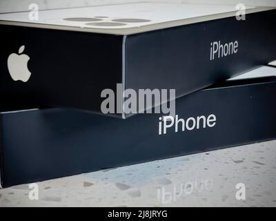 Seattle, WA USA - circa May 2022: View of two iPhone 13 Pro boxes on a kitchen counter inside a home Stock Photo