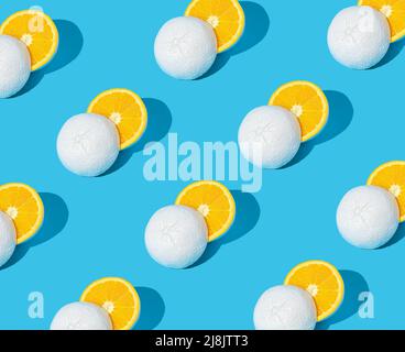 Pattern made of white painted yellow grapefruit cut in half on pastel blue background. Minimal summer concept. Stock Photo