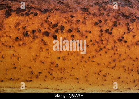 Rusted yellow orange painted metal wall. Rusty metal background with streaks of rust. Rust stains. Stock Photo