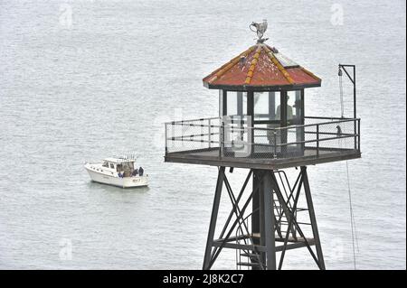 Prison, watch tower an angler boat on the sea, USA, California, San Francisco, Alcatraz Island Stock Photo