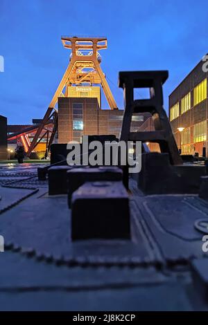 Model and original headframe of Zollverein Coal Mine Industrial Complex shaft XII in the evening, Germany, North Rhine-Westphalia, Ruhr Area, Essen Stock Photo