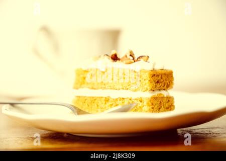 Homemade carrot cake served with a cup of tea Stock Photo