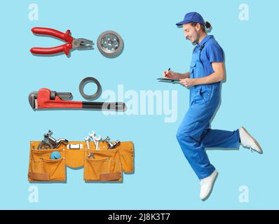 Jumping male plumber and different equipment on light blue background Stock Photo