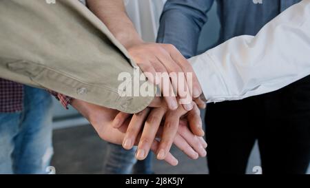 Close-up group unrecognizable people team fold hands put palms together unite employees teamwork motivation for success do common business support Stock Photo