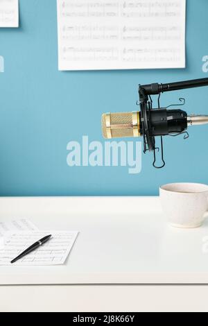 Stand with professional microphone near composer's workplace Stock Photo