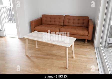 Brown couch and wooden coffee table in living room Stock Photo