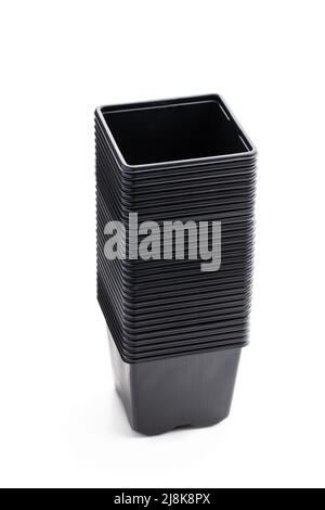 Stack  of black plastic pots isolated on white background Stock Photo