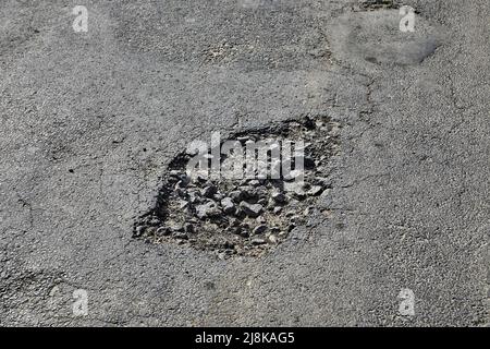 Potholes on the road Stock Photo