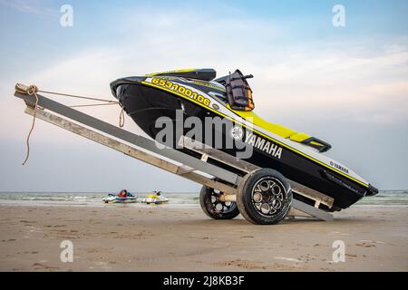 HUA HIN, THAILAND, MARCH 13 2022, A jet ski loaded on a transit cart on a sea beach at sunset Stock Photo
