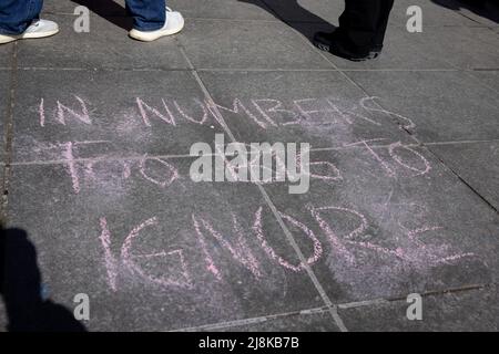 NEW YORK, N.Y. – March 7, 2021: People stand near a chalked message at a Manhattan rally in support of the Equal Rights Amendment. Stock Photo