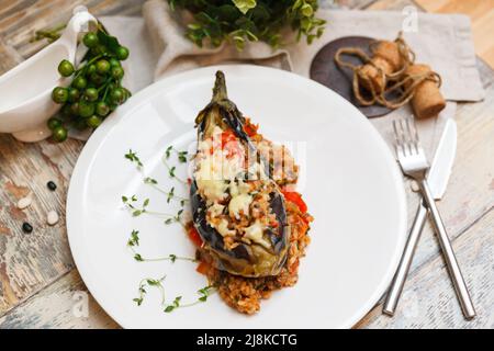 Imam bayıldı (Imam in fainting) is a traditional Turkish dish - eggplant stuffed with ground beef, vegetables, rice and salted cheese Stock Photo