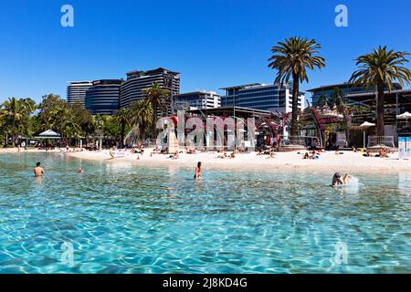 Brisbane Australia / Bathers enjoy the sunshine and swimming at Streets Beach an urban man made swimming beach. Stock Photo