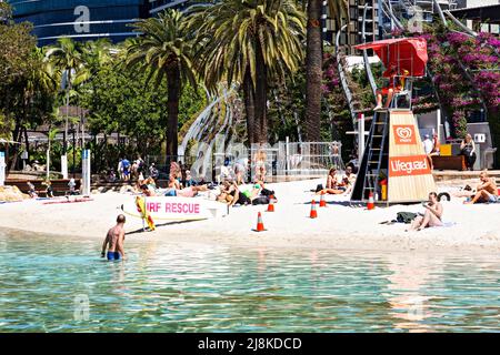 Brisbane Australia / Bathers enjoy the sunshine and swimming at Streets Beach an urban man made swimming beach. Stock Photo