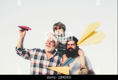 Generation of people and stages of growing up. Excited teach. Enjoy family together. Grandfather with son and grandson having fun in park. Happy man Stock Photo