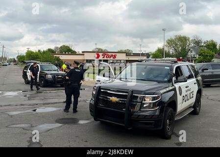 New York, USA. 16th May, 2022. Police work near the scene of a mass shooting in Buffalo of New York State, the United States, May 16, 2022. A heavily armed 18-year-old white man shot and killed 10 people and injured three others at a supermarket in Buffalo of New York State on Saturday. Credit: Zhang Jie/Xinhua/Alamy Live News Stock Photo