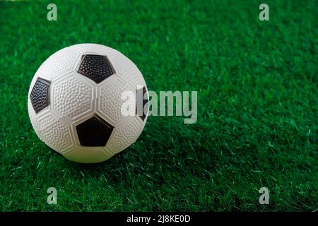 Close up of soccer ball on green background. Stock Photo