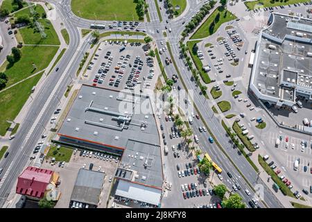 aerial overhead view of residential district with shopping malls, parking lots and city roads intersection Stock Photo