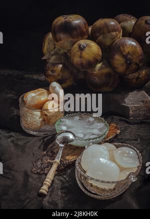 Sliced sweet fresh toddy palm with syrup and shaved ice in glass bowl. Thai Dessert call Louk Tarn Loi Gaew, Selective Focus. Stock Photo