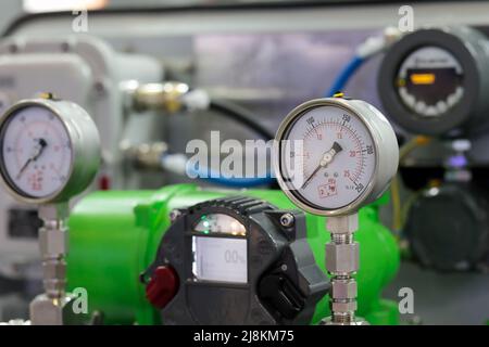 Analog pressure gauges and digital flowmeters. Selective focus. Stock Photo