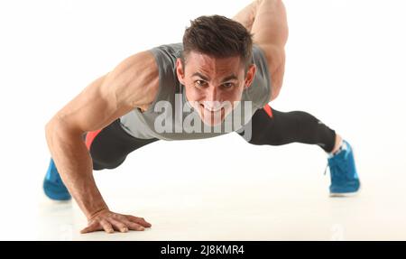 Strong man perform biceps and triceps workout at home without equipment Stock Photo