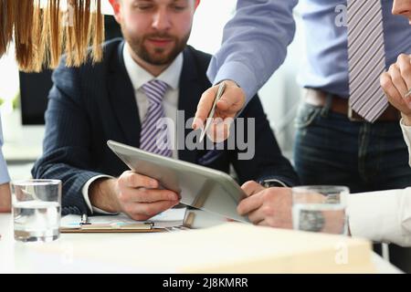 Coworkers busy in office, solve and discuss current problems, chaos on working place Stock Photo