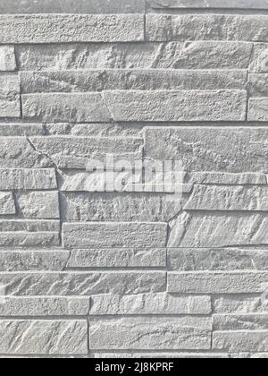 Stone gray backgrounds. Decorative rock. Wall. Facing with natural stone. Wall. Stock Photo