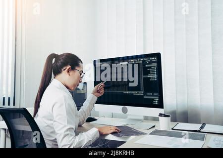 Developing programming and coding technology working in a software engineers developing applications in office. Stock Photo