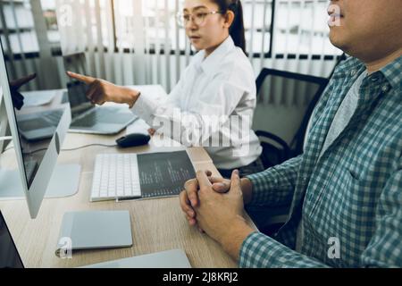 Two asian team working development of programming and encryption technology website design programmers on desk in office. Stock Photo