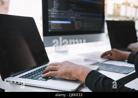 Professional development programmer cooperating meeting programming website working a software in office room. Stock Photo