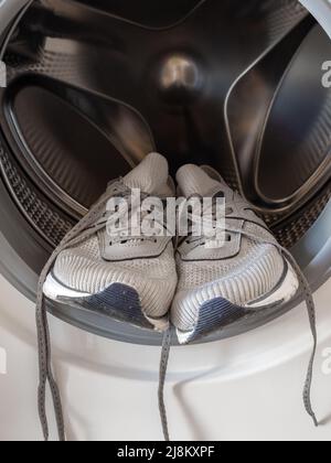 Sneakers inside the washing machine Stock Photo