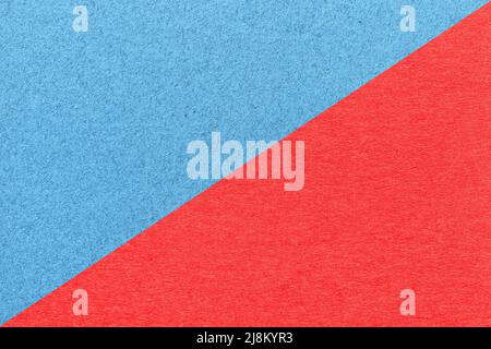 Texture of craft light blue and red paper background, half two colors, macro. Structure of vintage dense cardboard. Felt backdrop closeup. Stock Photo