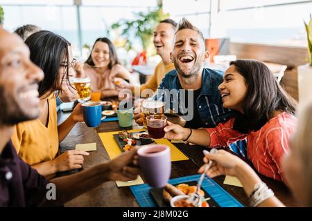 United group of multiracial young friends having breakfast at bar cafeteria Stock Photo