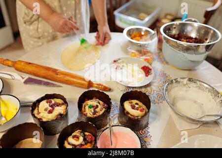 Easter cakes sprinkled against the backdrop of the cooking process. Ready Easter cakes for Orthodox Easter. Easter baking. Home made cooking Stock Photo