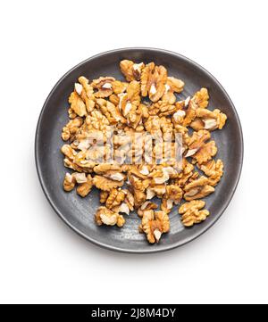 Peeled walnut kernels on plate isolated on a white background. Stock Photo