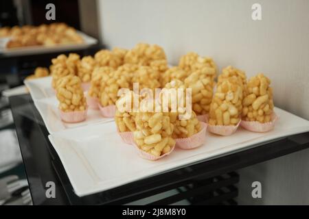 Peanuts in sugar glazed, oriental sweetness of brittle. Kozinaks are broken into pieces on a wooden Board, copy space Stock Photo