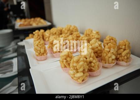 Peanuts in sugar glazed, oriental sweetness of brittle. Kozinaks are broken into pieces on a wooden Board, copy space Stock Photo