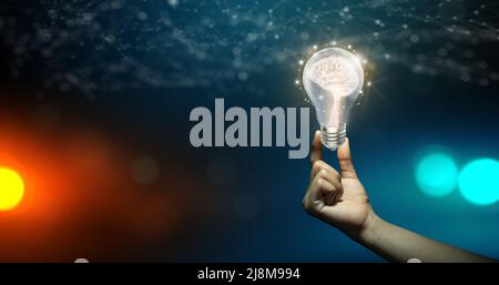 Businessman holding Light bulbs with Brain inside and Low poly wireframe outside. Creative and innovation inspiration. Business Bright idea concept. Stock Photo