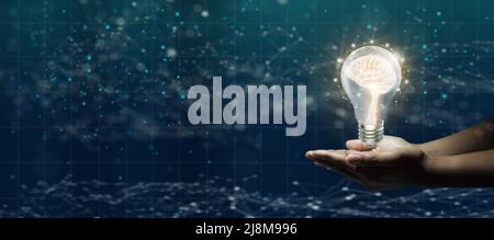 Businessman hand holding light bulbs with brain inside. Abstract blue technology background. ideas of new ideas with innovative technology, creativity Stock Photo
