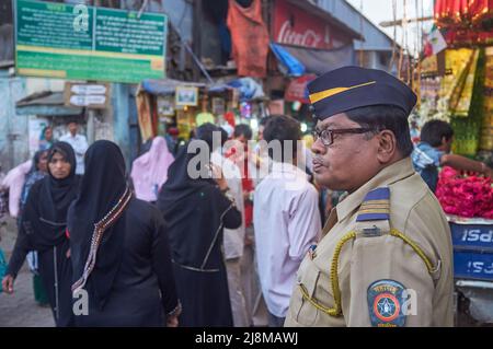 A policeman watches over the crowd visiting Mira Datar Dargah in
