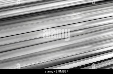 Steel rolled metal products. Stack of round, square, hexagonal steel rods Stock Photo