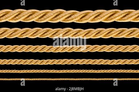collection of various golden ropes string on black background Stock Photo