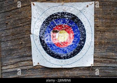 Close-up of an archery shooting target paper with lots of holes. Bullseye in bow and arrow shooting range Stock Photo