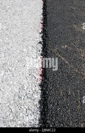layer of fresh black asphalt on grey gravel Stock Photo