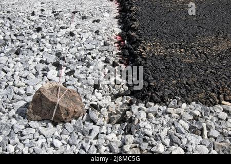 layer of fresh black asphalt on grey gravel Stock Photo