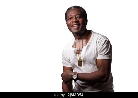 Smiling African mature man dressed in a white t-shirt isolated on white background. Black person headshot Stock Photo