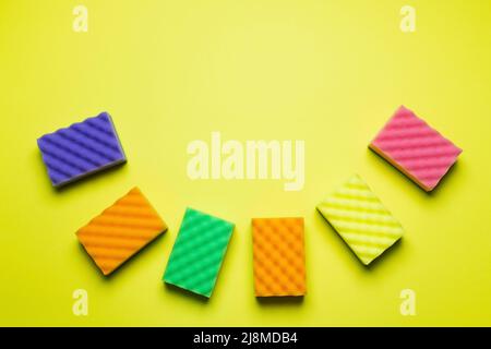 top view of textured multicolored sponges on yellow background Stock Photo
